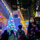 People wearing face masks amid concerns of the Covid-19 coronavirus walk past a Christmas display at a shopping mall in the Wanchai district of Hong Kong on December 24, 2020.